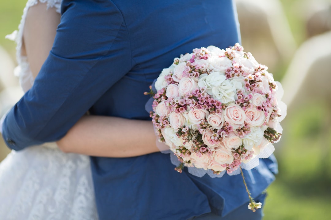 person holding rose bouquet