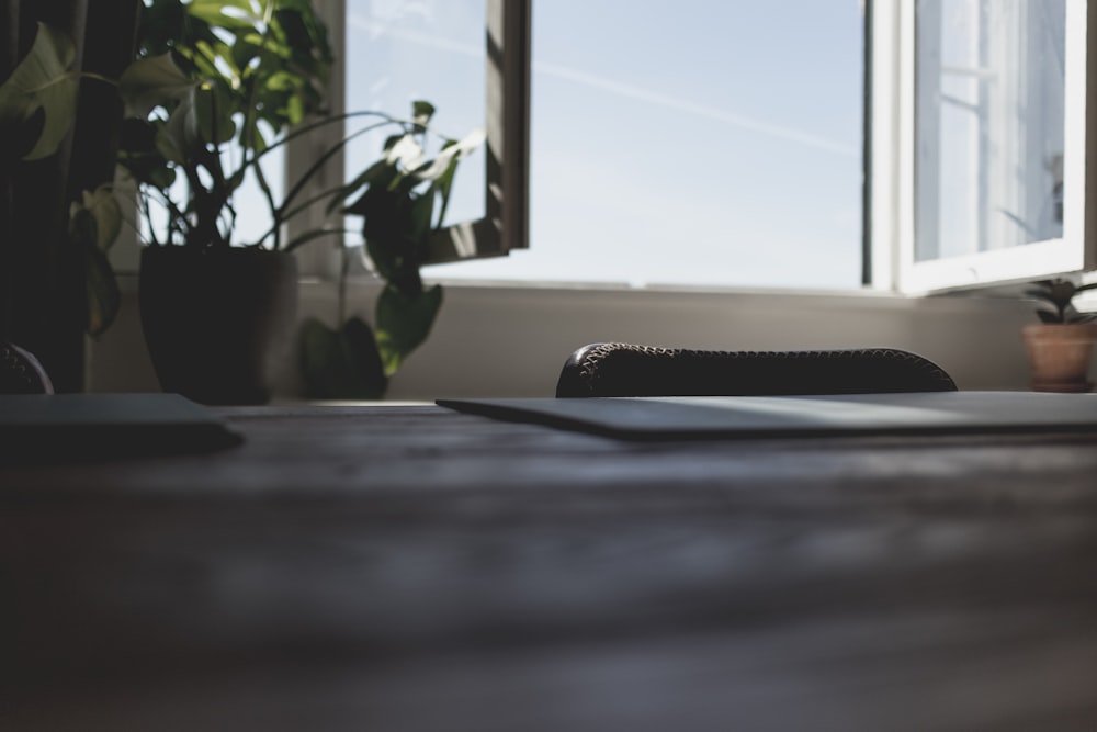 a laptop computer sitting on top of a wooden desk