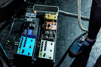 person standing beside assorted-color guitar tuner lot