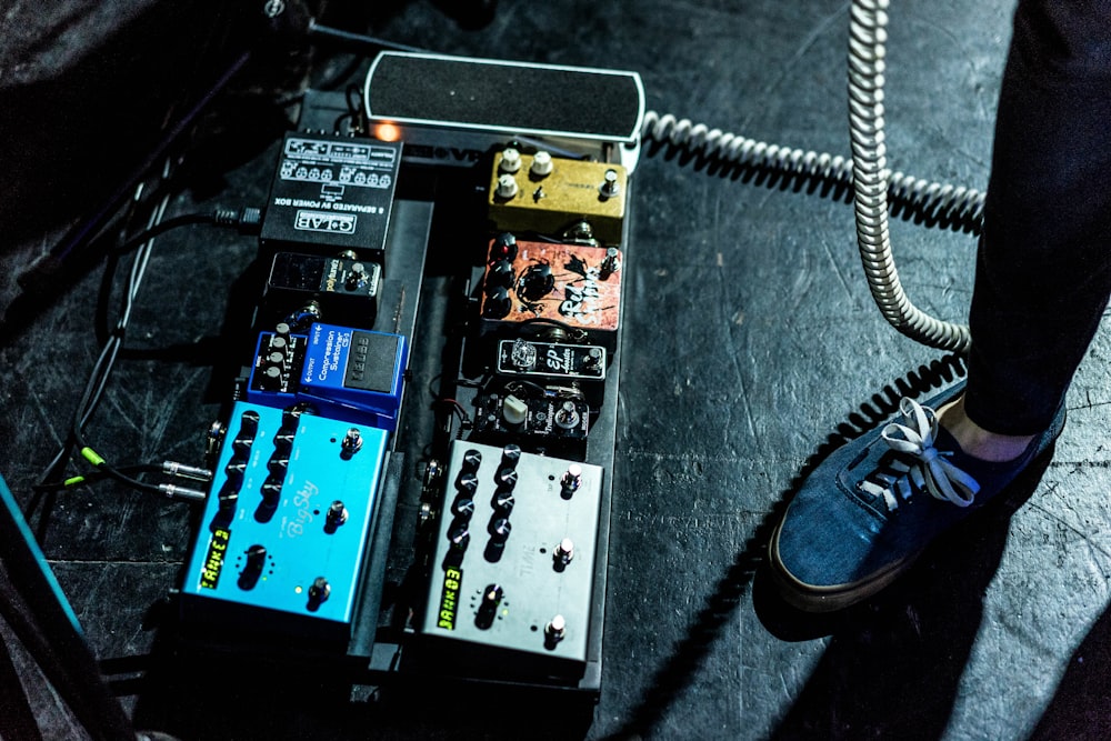 person standing beside assorted-color guitar tuner lot