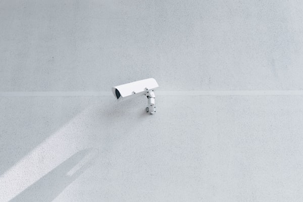 White box security camera on a wall
