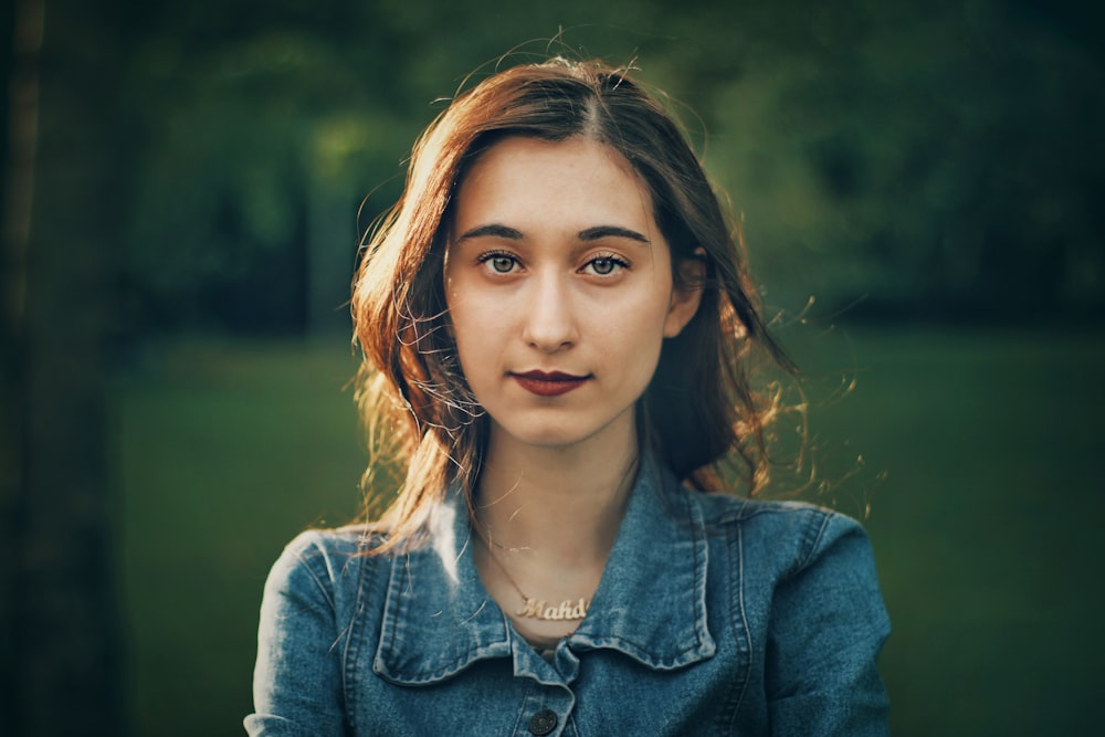 woman wearing blue button-up denim jacket