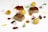 An elegant food presentation featuring two pieces of cooked meat, accompanied by small, round potato croquettes. Herb garnishes and edible flowers are artfully scattered around the plate, with drops and splatters of rich brown sauce adding a creative touch.