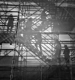 black and white photo of people going upstairs