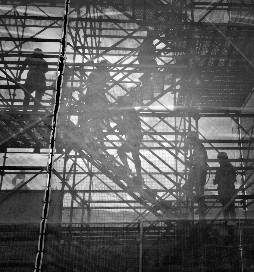 Workers walking up scaffolded stairs