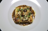 A beautifully plated dish of gourmet pasta with herbs.
