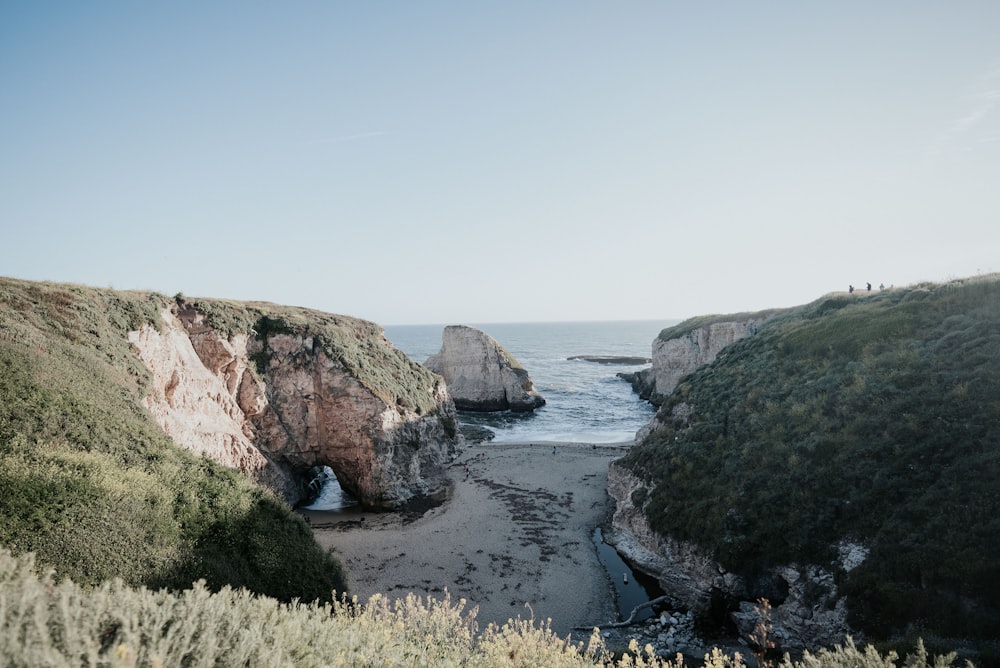 body of water beside mountains