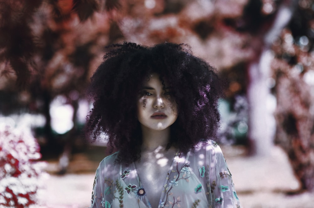 selective focus photography of woman in white floral shirt