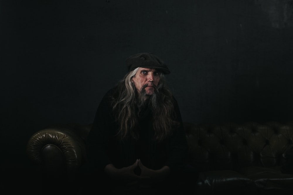 man sitting on brown couch