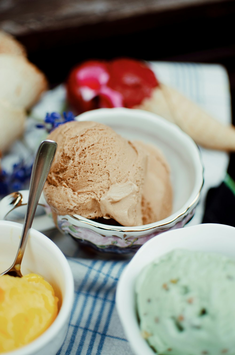 three assorted-flavor ice cream on bowls