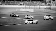 A historic photograph of the Alabama Gang at a racetrack.