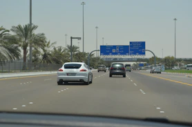 Moving truck driving through Abu Dhabi city streets.