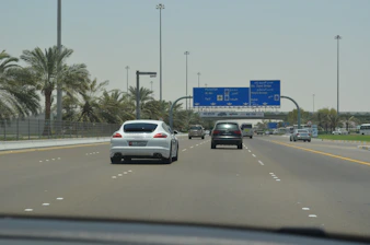 Moving truck driving through Abu Dhabi city streets.