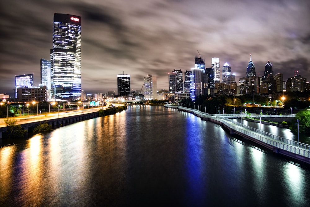 aerial view of city buildings and lake during nighttime