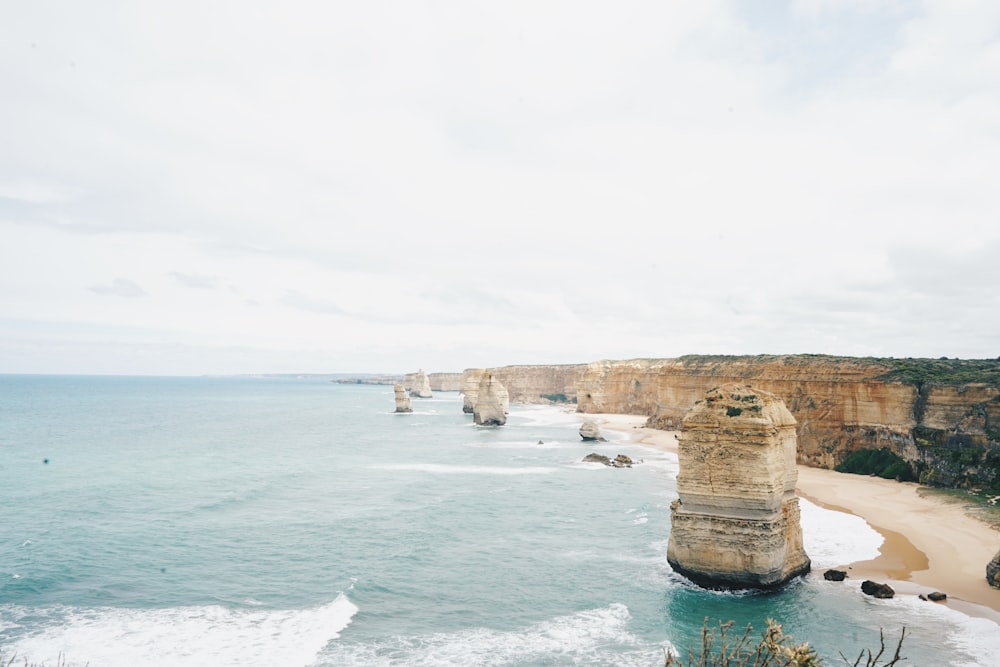 panoramic photography of body of water and stone formations