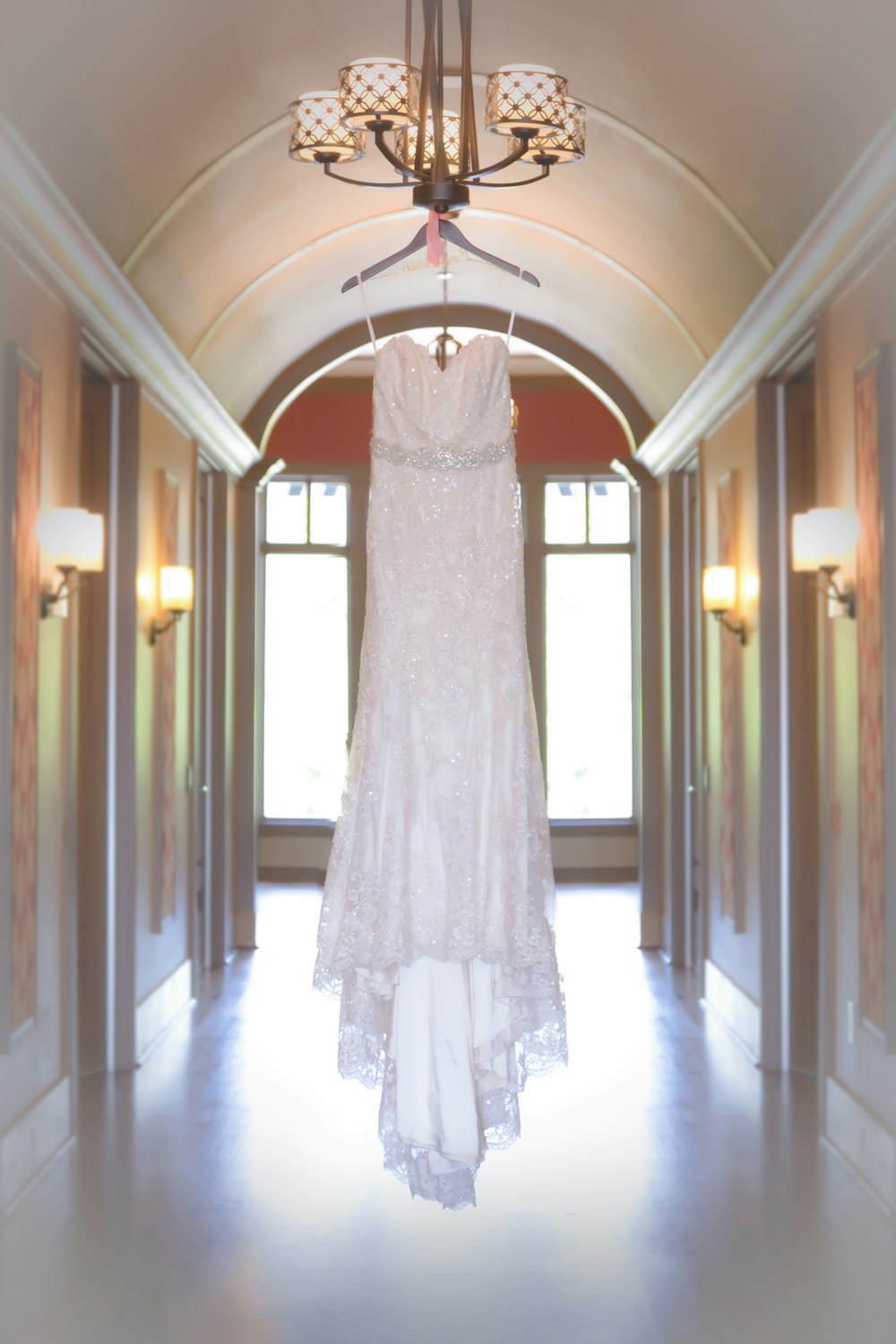 white spaghetti strap dress hang on chandelier