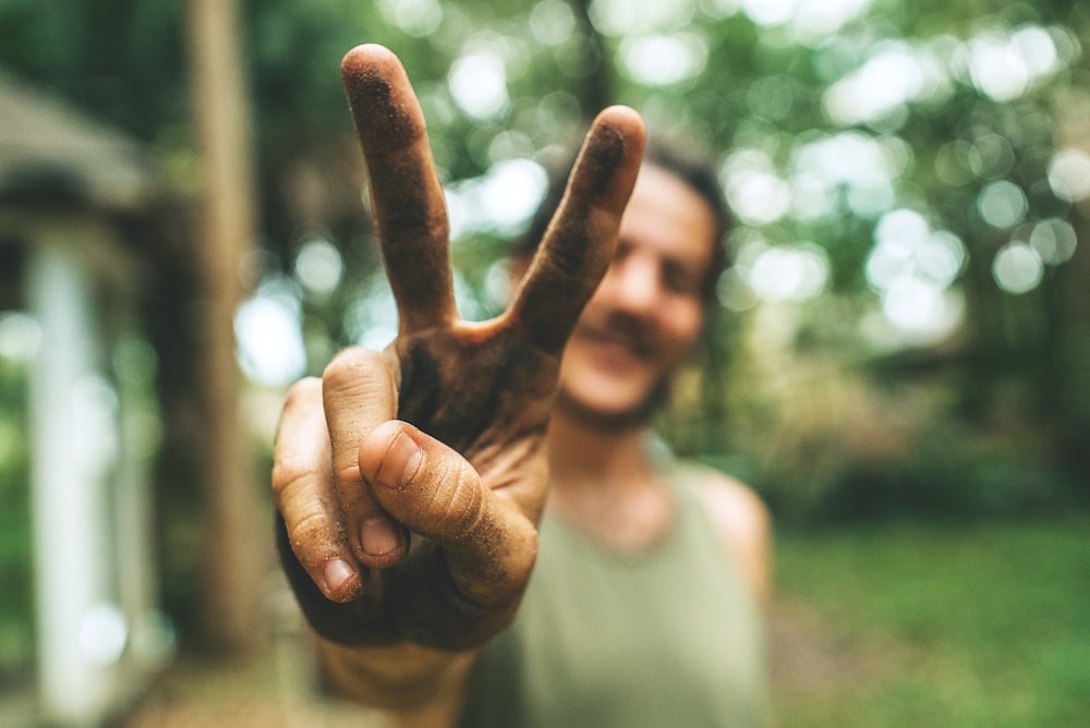 person doing peace sign