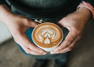 focus photography of coffee artwork