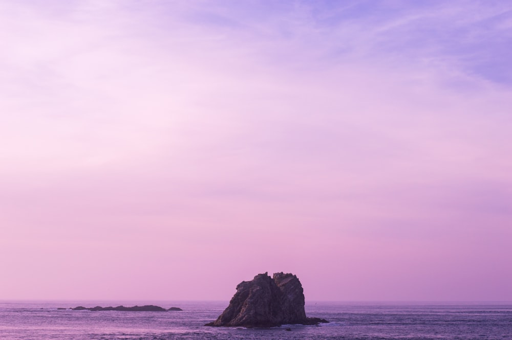 rock formation surrounding by body of water