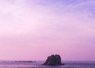 rock formation surrounding by body of water