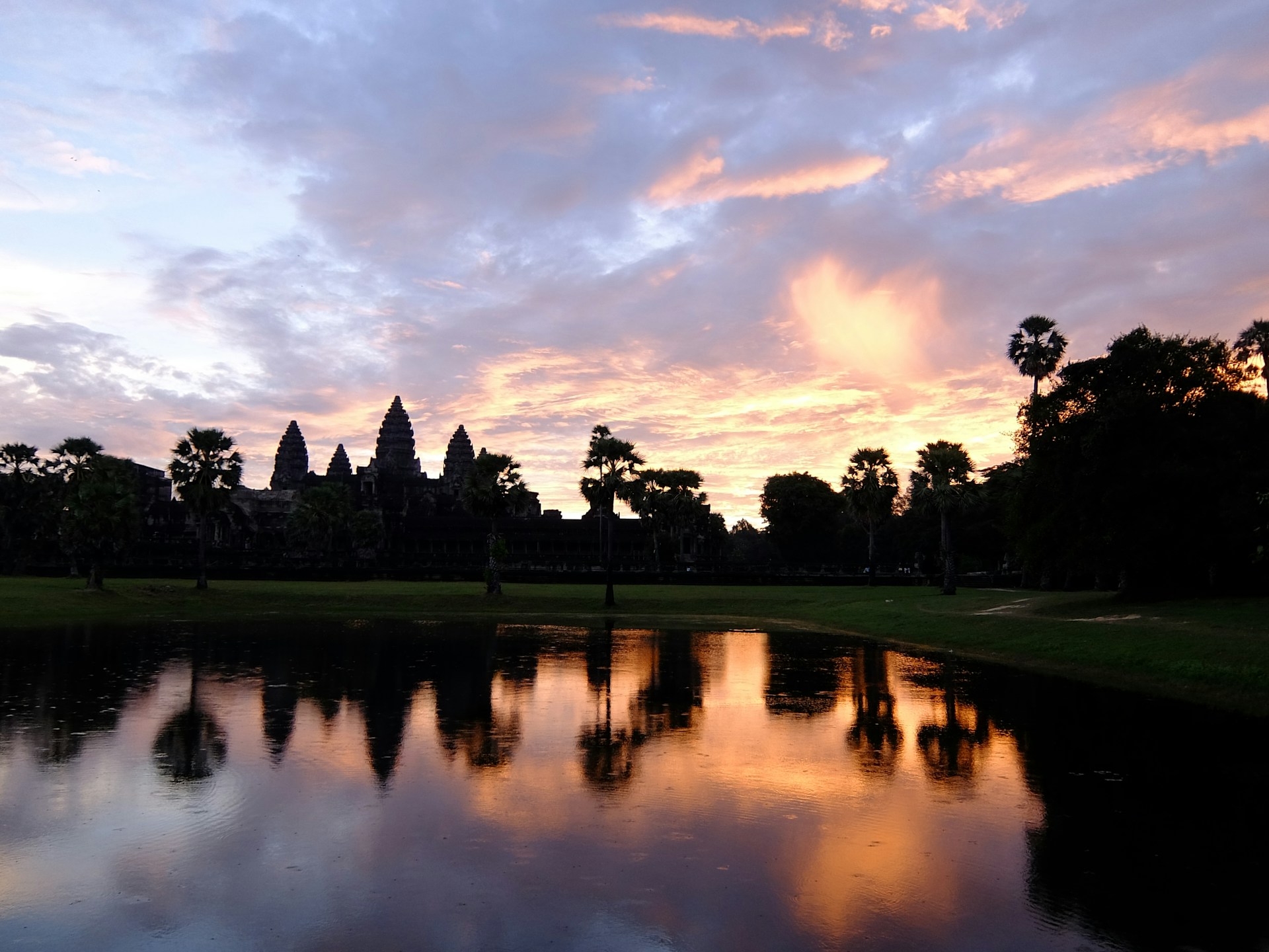 A panoramic view of the ancient temples of Angkor Wat at sunrise, showcasing the mystical beauty Baha experienced in Cambodia.