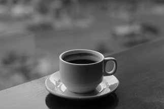 An inviting image of a coffee cup with a drone in the background.