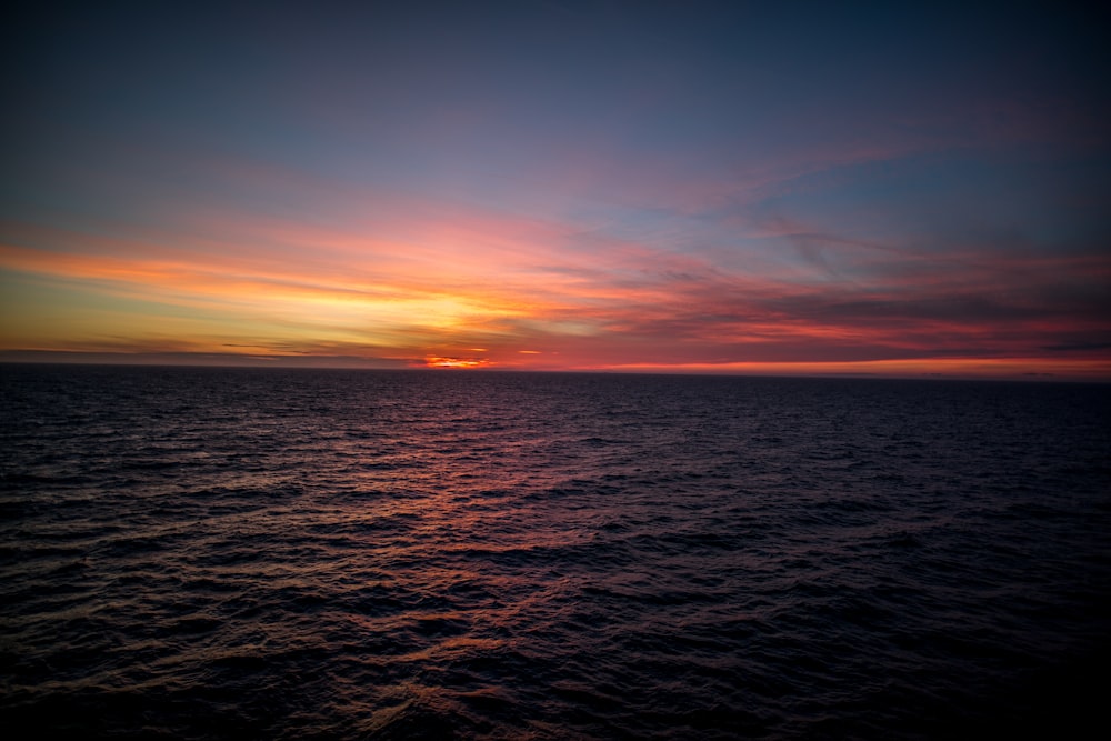 landscape photo of body of water during golden hour