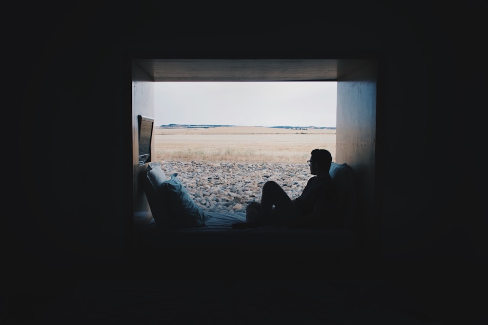 person sitting while looking outside