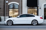 white car parked near building