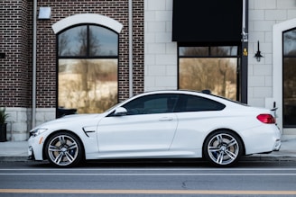 white car parked near building