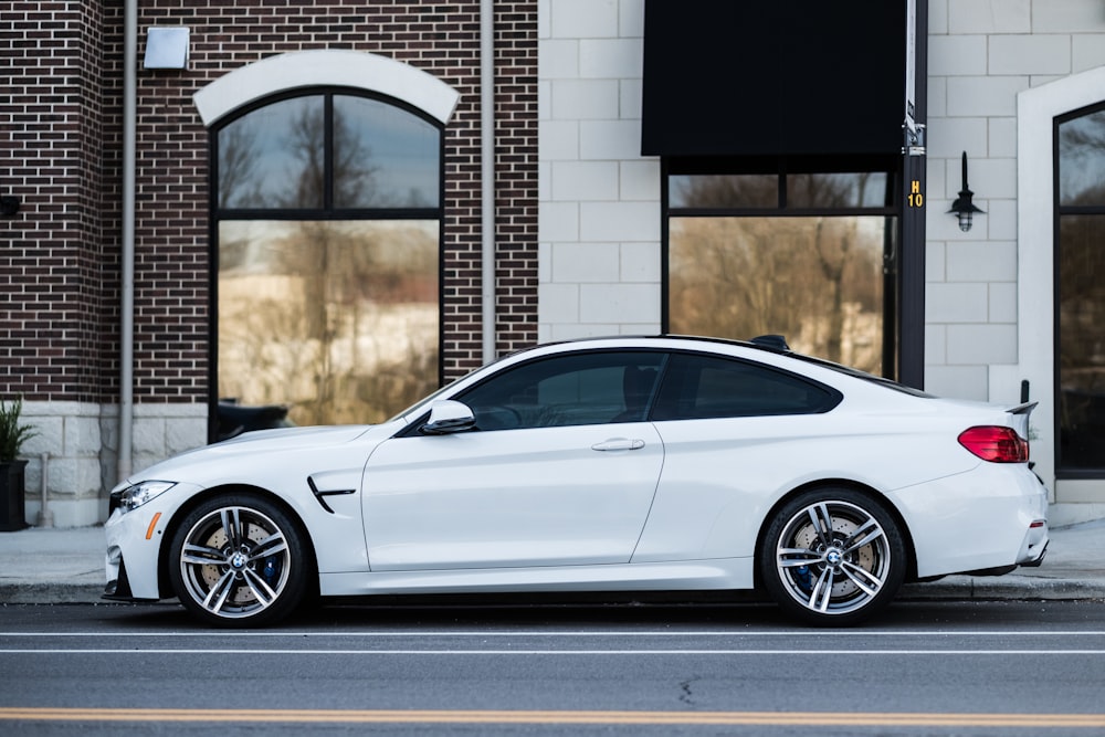 white car parked near building