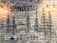 A brick wall features black stenciled oil derricks and industrial-style lighting fixtures. The name 'Spindletap' is prominently displayed in bold letters, with the word 'Brewery' below. A small blue silhouette of Texas is visible near the bottom.