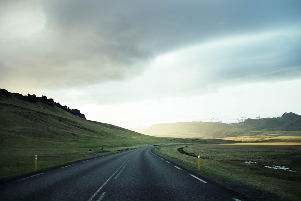 white line open road under cloudy skies