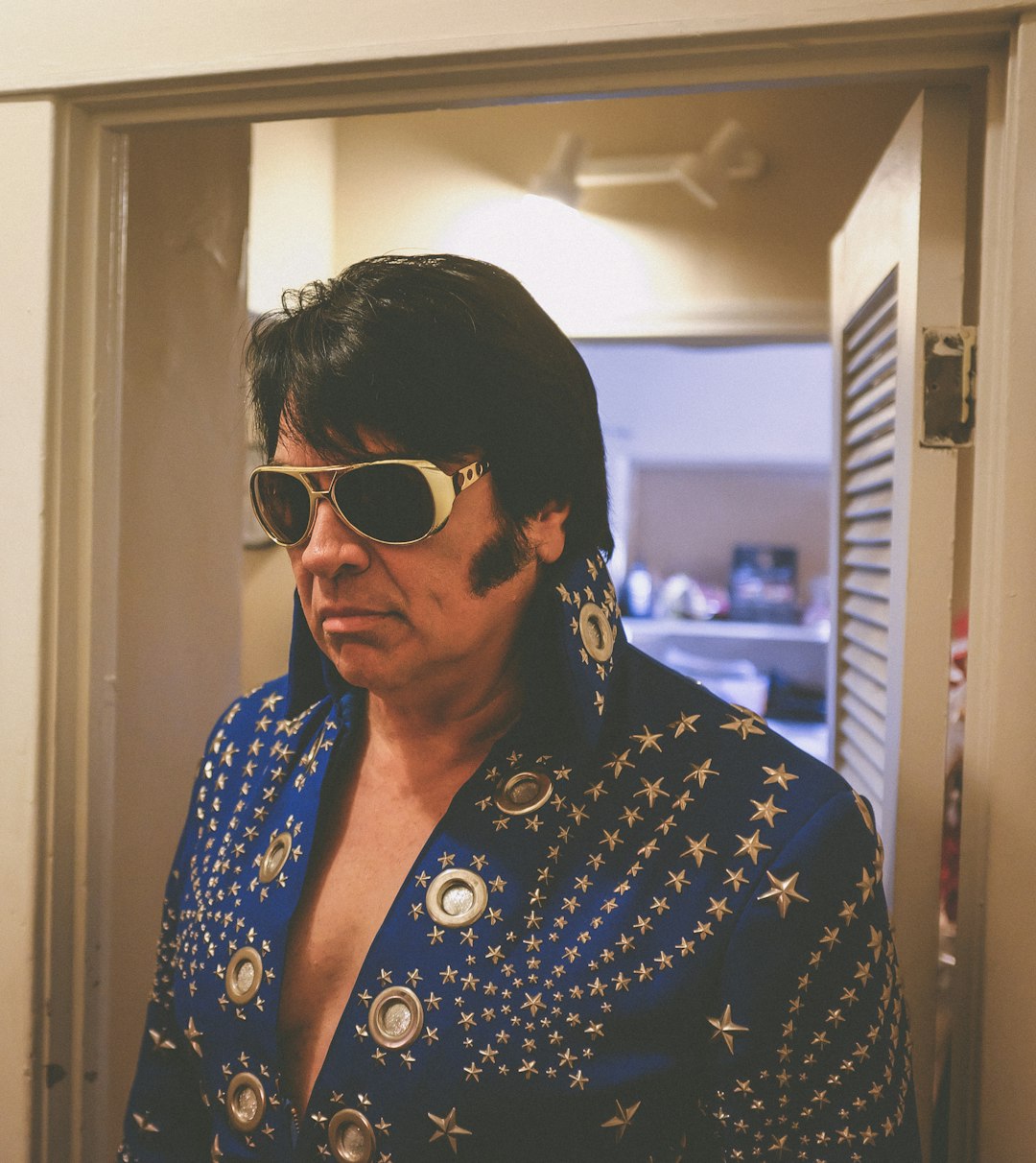 man wearing Elvis Presley costume at the doorway