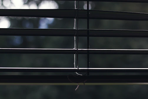 Installation technician setting up smart blinds in a bright, modern home