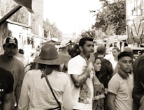 Volunteers distributing food and clothing to people in need on a bustling city street.