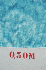 Close-up of a pool technician testing water chemistry with a digital meter.