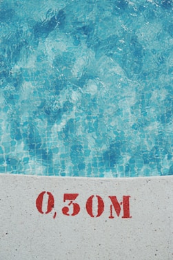 A technician carefully testing pool water quality with professional equipment.