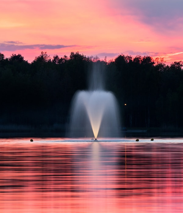 water fountain during sunset