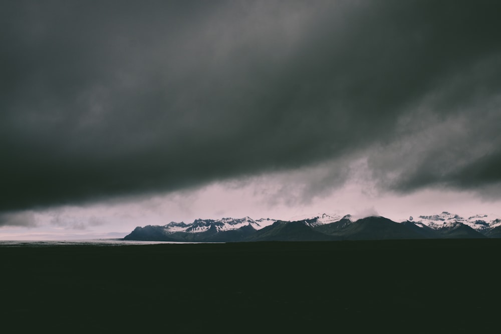 snow covered mountain during cloudy day