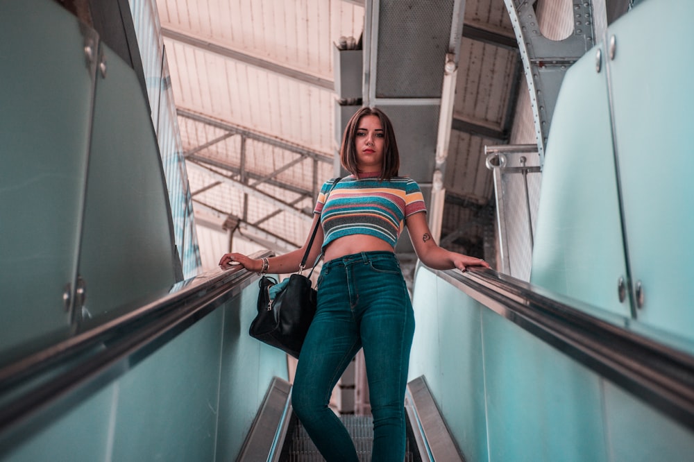 woman standing on escalator