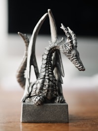 Close-up of a detailed 3D-printed dragon figurine with delicate scales and wings.
