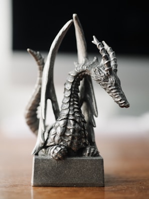 Close-up of a neon-lit dragon figurine with intricate scales glowing in electric blue.