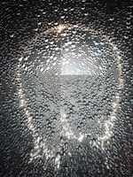 Shimmering glass beads scattered artistically, capturing the craftsmanship of Patra Enterprises.