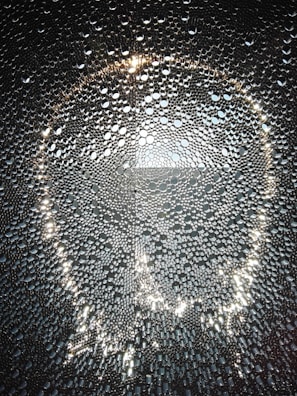 Shimmering glass beads scattered artistically, capturing the craftsmanship of Patra Enterprises.