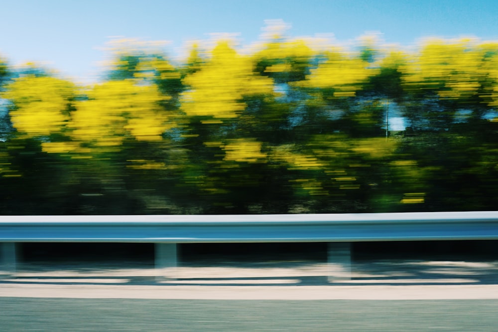 uma foto desfocada de uma rodovia com árvores ao fundo