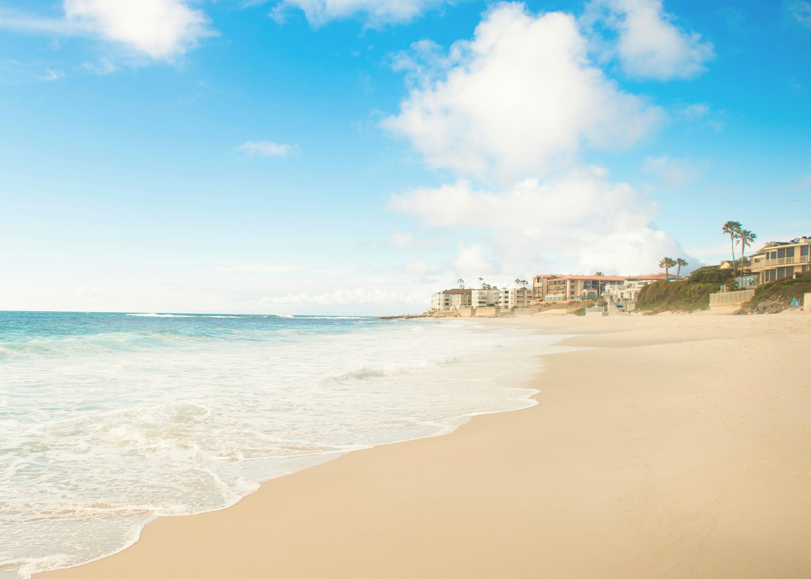 Nikon AF-S Nikkor 24mm F1.4G ED sample photo. Empty seashore near high-rise photography