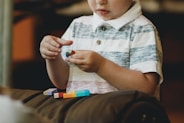 boy holding block toy