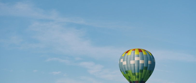 multi-colored hot air balloon flying on sky