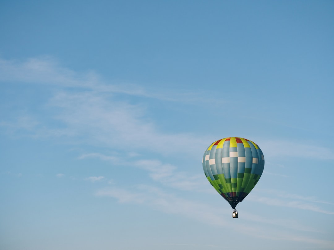 multi-colored hot air balloon flying on sky, Colorful hot air balloon in flight